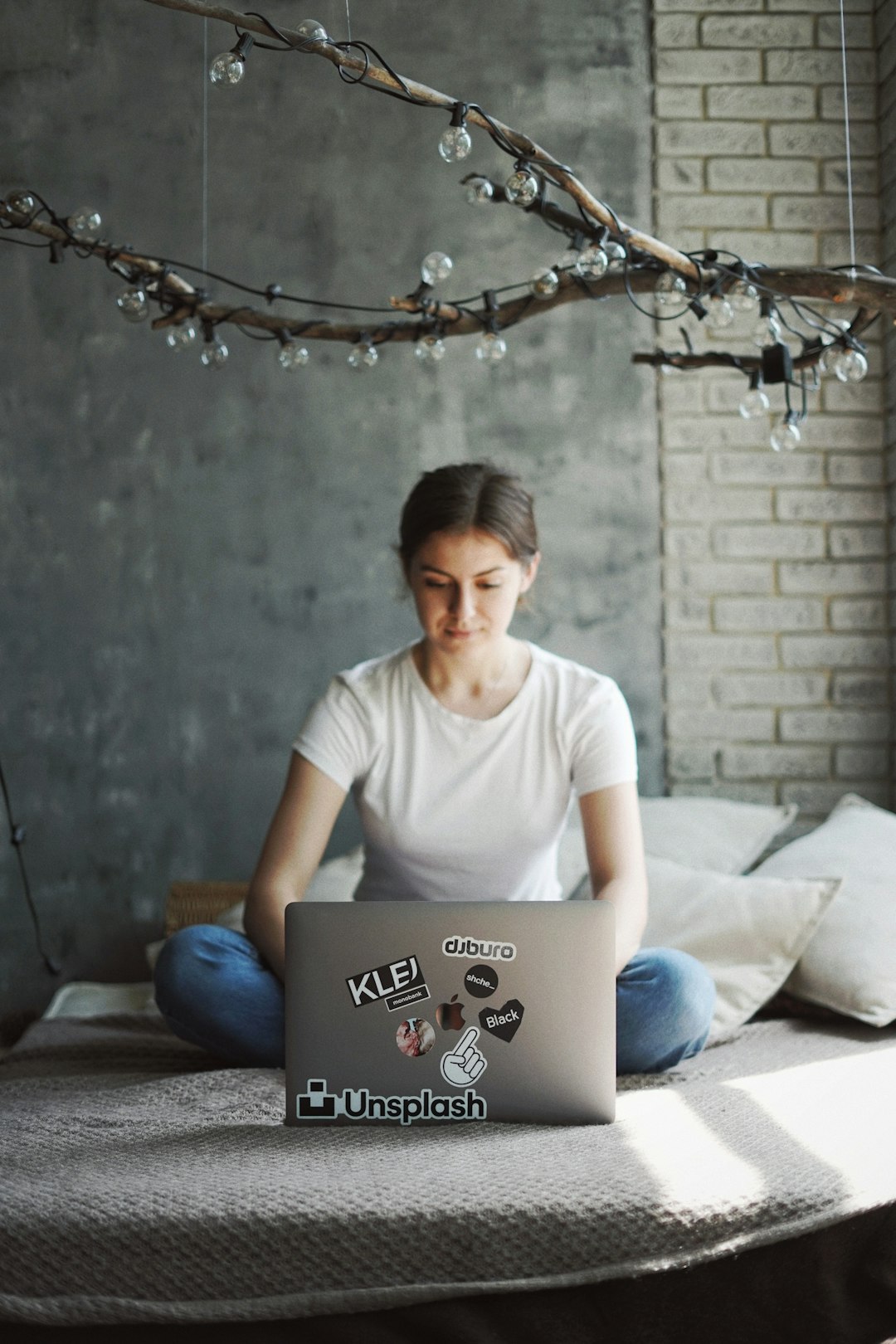 girl with laptop on the bed, unsplash sticker